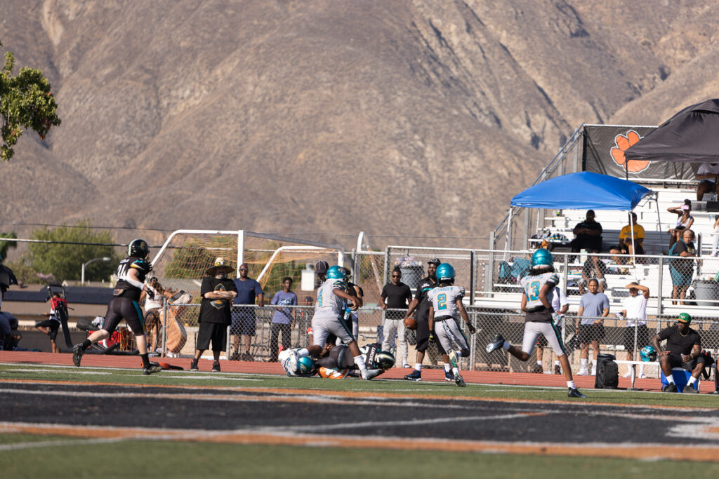 Riverside family photographer action shot of Inland Immortals 12U football player making a tackle"
"Hemet family photographer capturing 13U Inland Immortals football game"
"Inland Immortals cheer squad sideline photo by Riverside family photographer"