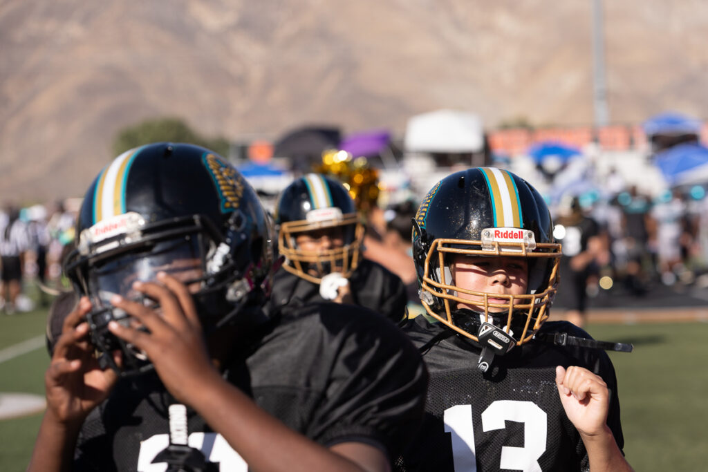 Riverside family photographer action shot of Inland Immortals 12U football player making a tackle"
"Hemet family photographer capturing 13U Inland Immortals football game"
"Inland Immortals cheer squad sideline photo by Riverside family photographer"